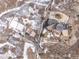 High-angle view of a home with a circular roofline, patios, and a large surrounding lot at 1175 Ridge Oaks Dr, Castle Rock, CO 80104