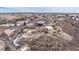 Stunning aerial view of a unique home on a hilltop with a circular design and surrounding landscape at 1175 Ridge Oaks Dr, Castle Rock, CO 80104