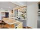 Modern wet bar with granite countertop and glass shelving at 1175 Ridge Oaks Dr, Castle Rock, CO 80104