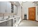 Bright laundry room, featuring washer, dryer, sink, and ample cabinetry at 1175 Ridge Oaks Dr, Castle Rock, CO 80104