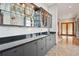 Wet bar with glass shelving and granite countertop at 1175 Ridge Oaks Dr, Castle Rock, CO 80104