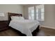 Bedroom with hardwood floors, complemented by natural light and a comfortable queen bed at 6172 N Liverpool St, Aurora, CO 80019