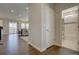 Hallway leads to living spaces and bathroom with wood floors and neutral paint scheme at 6172 N Liverpool St, Aurora, CO 80019