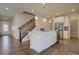 Modern kitchen island with pendant lighting and stainless steel appliances at 6172 N Liverpool St, Aurora, CO 80019