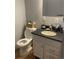 Bathroom with tiled floor, granite countertop, toilet, and vanity at 561 E Geneva N St # 103, Aurora, CO 80010