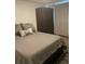 Bedroom features a neutral color palette, a full bed, and a wardrobe at 561 E Geneva N St # 103, Aurora, CO 80010