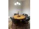 Cozy dining area features a round table with black leather chairs under modern lighting at 561 E Geneva N St # 103, Aurora, CO 80010