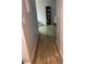 Hallway showing the laminate floors and a bookcase in the background at 561 E Geneva N St # 103, Aurora, CO 80010