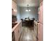 Eat-in kitchen featuring white cabinetry, modern appliances, and an adjacent dining area with seating at 561 E Geneva N St # 103, Aurora, CO 80010
