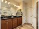 Bathroom featuring double vanity with granite countertop and wood cabinets at 12164 Adams St, Thornton, CO 80241
