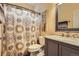 Cozy bathroom with decorative shower curtain and granite countertop at 12164 Adams St, Thornton, CO 80241