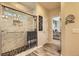 Modern bathroom with glass shower, stone floors, and granite countertop at 12164 Adams St, Thornton, CO 80241