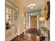 Inviting entryway with hardwood floors, glass French doors, and modern decor at 12164 Adams St, Thornton, CO 80241
