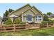 Charming single-story home with a well-manicured lawn, fenced yard, and inviting outdoor seating at 12164 Adams St, Thornton, CO 80241