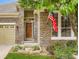 Close up of the stone elevation and front entry of this charming home at 12164 Adams St, Thornton, CO 80241