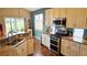 Modern kitchen featuring granite counters, stainless appliances, and hardwood flooring at 12164 Adams St, Thornton, CO 80241