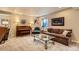 Cozy living room with a piano, patterned sofa, and window providing natural light at 12164 Adams St, Thornton, CO 80241