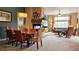 Open-concept living room and dining area with fireplace, comfortable seating, and natural light at 12164 Adams St, Thornton, CO 80241