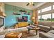 Bright living room with stone fireplace, large windows, and modern decor, perfect for relaxation and entertaining at 12164 Adams St, Thornton, CO 80241