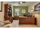 Functional office with built-in shelving, ample desk space, and comfortable seating, conducive to productivity at 12164 Adams St, Thornton, CO 80241