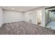 A finished basement featuring carpet and access to a nearby bathroom at 6914 E Briarwood Dr, Centennial, CO 80112