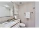 Bathroom featuring a granite countertop, toilet, and a shower with white tiling at 6914 E Briarwood Dr, Centennial, CO 80112