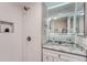 Bathroom features a tile shower, granite countertop, and a decorative vanity mirror at 6914 E Briarwood Dr, Centennial, CO 80112