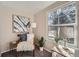 Cozy bedroom nook with a chair, cushions, and a large window with a view at 6914 E Briarwood Dr, Centennial, CO 80112