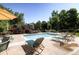 Community pool area with lounge chairs, umbrellas, and lush landscaping, perfect for relaxation and recreation at 6914 E Briarwood Dr, Centennial, CO 80112