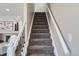 Carpeted staircase with white railings leading to upper level at 6914 E Briarwood Dr, Centennial, CO 80112