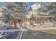 Charming two-story home with a brick facade and a cozy front porch, nestled among mature trees and manicured landscaping at 6914 E Briarwood Dr, Centennial, CO 80112