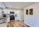 Modern kitchen featuring white cabinets, stainless steel appliances, and stylish countertops at 6914 E Briarwood Dr, Englewood, CO 80112