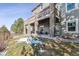 Stone patio and backyard with deck and hillside view at 1575 Ridgetrail Ct, Castle Rock, CO 80104