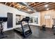 Well-equipped basement gym featuring exposed ceiling, rubber flooring, and mirrored walls at 1575 Ridgetrail Ct, Castle Rock, CO 80104