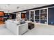 The basement features a cozy sectional, abundant natural light, and built in shelving at 1575 Ridgetrail Ct, Castle Rock, CO 80104