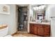 Bathroom with a vanity and stone-tiled walk-in shower with frameless glass door at 1575 Ridgetrail Ct, Castle Rock, CO 80104