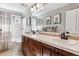 Shared bathroom with a double vanity and a tub shower combo at 1575 Ridgetrail Ct, Castle Rock, CO 80104