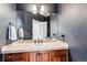 Stylish bathroom featuring a vanity with stone countertop and dark gray painted walls at 1575 Ridgetrail Ct, Castle Rock, CO 80104