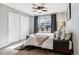 Cozy bedroom with a comfortable bed, closet, and a large window at 1575 Ridgetrail Ct, Castle Rock, CO 80104