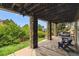 Covered patio with stone pillars, a porch swing, and scenic views of the backyard at 1575 Ridgetrail Ct, Castle Rock, CO 80104
