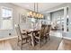 Elegant dining room featuring hardwood floors, a large window, and modern chandelier at 1575 Ridgetrail Ct, Castle Rock, CO 80104