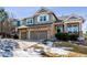 Two-story house with stone accents, two-car garage, and a landscaped yard at 1575 Ridgetrail Ct, Castle Rock, CO 80104