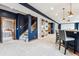 Stylish finished basement with cozy carpet, built-in shelves, and a convenient wet bar at 1575 Ridgetrail Ct, Castle Rock, CO 80104