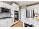Modern kitchen with stainless steel appliances, white cabinets, and a wine cooler at 1575 Ridgetrail Ct, Castle Rock, CO 80104