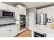 Modern kitchen with double ovens, stainless steel appliances, and white cabinetry at 1575 Ridgetrail Ct, Castle Rock, CO 80104