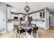 Eat-in kitchen with white cabinetry, stainless steel appliances, a kitchen island, and pendant lighting at 1575 Ridgetrail Ct, Castle Rock, CO 80104