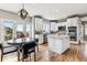 Bright eat-in kitchen features white cabinets, stainless appliances, a central island and lots of natural light at 1575 Ridgetrail Ct, Castle Rock, CO 80104