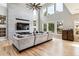Spacious living room boasts soaring ceilings, a modern fireplace, and a wall of windows, filling the space with light at 1575 Ridgetrail Ct, Castle Rock, CO 80104