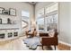 Bright living room featuring hardwood floors, many large windows, and comfortable leather chairs at 1575 Ridgetrail Ct, Castle Rock, CO 80104