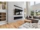 Stylish living room with fireplace, large television, and recessed lighting create a comfortable, modern living space at 1575 Ridgetrail Ct, Castle Rock, CO 80104